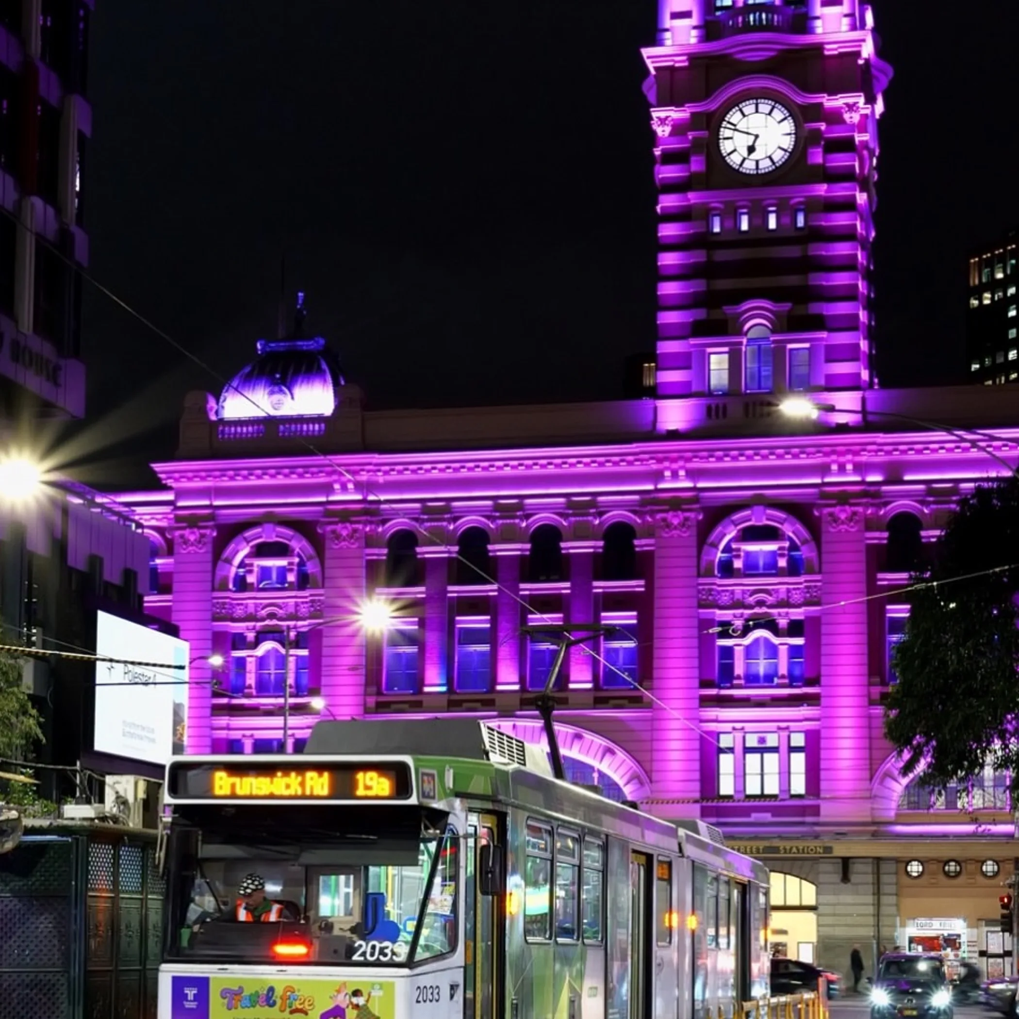 melbourne tram at night illuminated building
